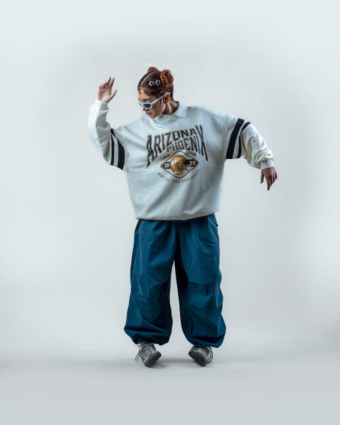 Trendy adult wearing oversized retro clothing, striking a pose with style and attitude.